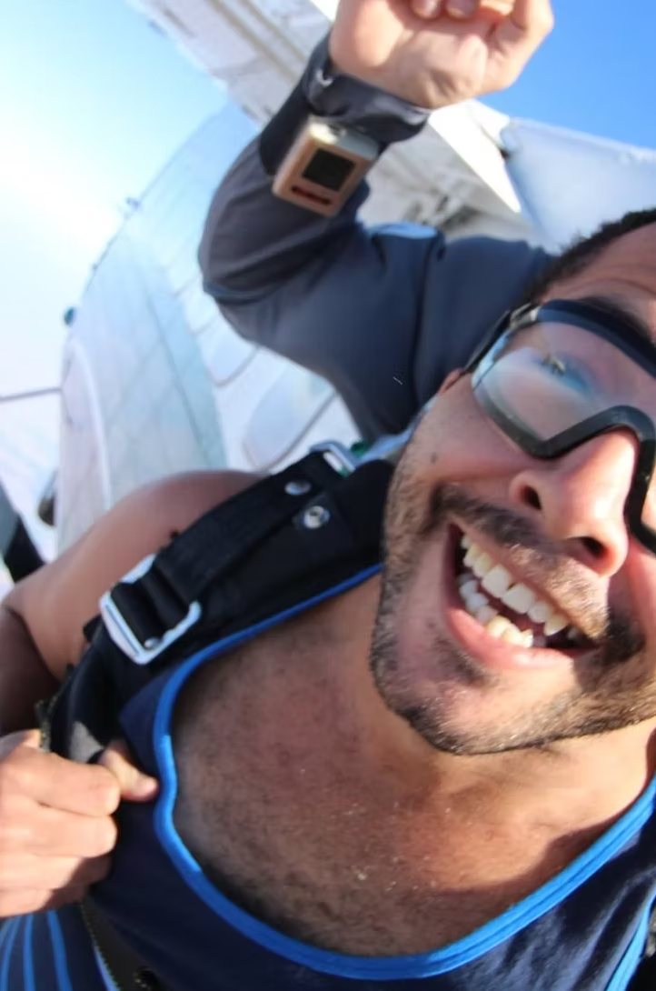 Jezza grinning in goggles, mid-skydive